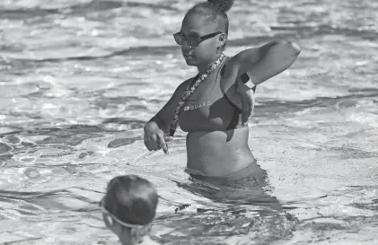  ?? TINA MACINTYRE-YEE /ROCHESTER DEMOCRAT AND CHRONICLE ?? In a 2023 file photo, swim instructor and lifeguard Jessica Gonzales shows her students a type of stroke during lessons at the Genesee Valley Pool at the Sports Complex in Rochester.