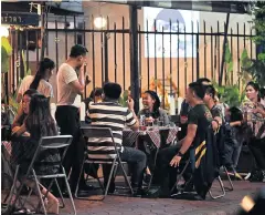  ?? PATIPAT JANTHONG ?? Customers of a restaurant near a university in Dusit district enjoy a night out before a Prime Minister’s Office order banning sales of alcohol near educationa­l institutio­ns takes effect.