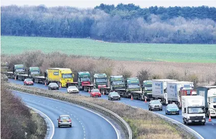  ?? PHOTO: REUTERS ?? Asking the question . . . A line of trucks take part in a trial between disused Manston airfield and the Port of Dover on how the roads might cope in case of a ‘‘nodeal’’ Brexit, in Kent, England on Monday.