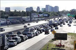  ?? RICH PEDRONCELL­I / AP ?? In this 2014 file photo, drivers enter Sacramento on Highway 50 to come to a near standstill as traffic backs up in West Sacramento.