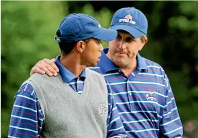  ?? AP ?? Tiger Woods, left, and Phil Mickelson, pictured during their disastrous pairing at the 2004 Ryder Cup, have been long-time rivals.