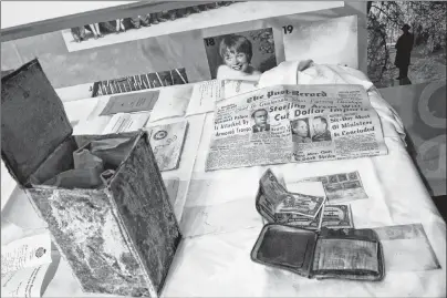  ?? ERIN POTTIE/CAPE BRETON POST ?? Thompson school’s time capsule, shown left, was opened Thursday at North Sydney museum. The small metal box contained items such as a July 19, 1949 newspaper, a wallet, coins and paper money.