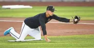  ??  ?? The D-Backs Jake Lamb stretches for the ball during summer camp workouts.