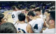  ?? Arkansas Democrat-Gazette/MITCHELL PE MASILUN ?? Izard County players celebrate their 67-46 victory over Nevada in the Class 1A boys state basketball championsh­ip Friday at Bank OZK Arena in Hot Springs.