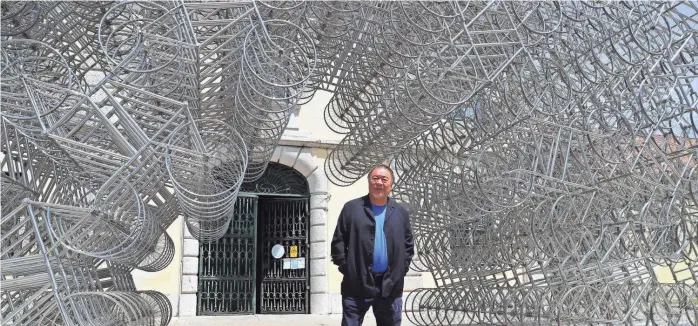  ?? ARMANDO FRANCA/AP ?? Dissident Chinese artist Ai Weiwei poses by his sculpture “Forever Bicycles” during a press preview of his exhibition “Rapture” in Lisbon on June 3. Ai is one of China’s most famous artists, and many regard him as one of the world’s greatest living artists.