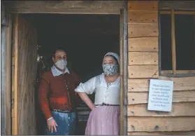  ??  ?? Museum educators Doug Blake (left) and Alexandra Cervenak, playing the roles of Pilgrims William and Alice Bradford, wait for visitors at Plimoth Plantation, a reconstruc­ted Pilgrim settlement and living history exhibit in Plymouth, Mass. After more than two months at sea, the Pilgrims landed at the place the Wampanoags called Patuxet, meaning “at the little falls.” When they disembarke­d from the leaky, fetid carrack, they stepped foot on a land already cleared by death’s scythe. (AP/David Goldman)