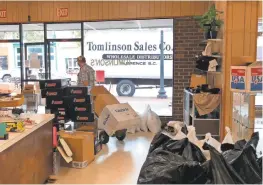  ?? JEFFREY COLLINS/AP ?? Employees at Tomlinson Department Store remove merchandis­e in case of flooding in Georgetown, S.C., on Monday.