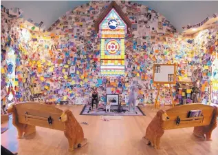  ?? LISA RATHKE/ASSOCIATED PRESS ?? The Dog Chapel at Dog Mountain shows where dog owners have grieved their lost pets by placing notes, numbering in the hundreds, on the walls of the St. Johnsbury, Vt., haven. A Vermont group is trying to preserve the site that draws visitors from...
