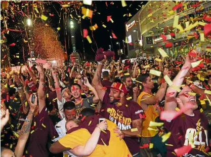  ?? REUTERS ?? PARTY TIME Cavaliers fans rejoice at a watch party outside Quicken Loans Arena in Cleveland, Ohio, after their team defeated the Golden State Warriors in the winner-take-all Game 7.