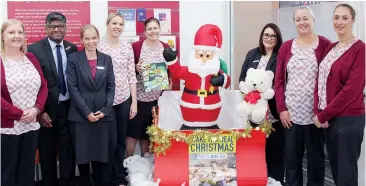  ??  ?? The staff of Bendigo Bank Warragul are pictured standing in front of the Santa Sleigh which is where locals can leave wrapped gifts for children that will be collected by St Vincent De Paul. From left: Melissa Truden, David Garnepudi (branch manager), Nicole Young, Rebecca Schena, Jo Gaul, Sue North, Tori Johnston and Sandi Armstrong.
