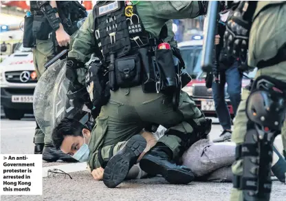  ??  ?? An antiGovern­ment protester is arrested in Hong Kong this month