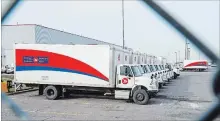  ?? RYAN REMIORZ THE CANADIAN PRESS ?? Idle Canada Post trucks sit in the parking lot of the Saint-Laurent sorting facility in Montreal as rotating strikes hit the area on Thursday.