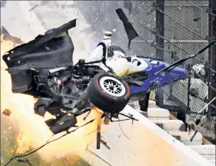  ?? UPI ?? FIRE FLIES: Pole-sitter Scott Dixon’s flaming car goes airborne after contact with Jay Howard that led to a crash during Lap 53 of the Indy 500 on Sunday.