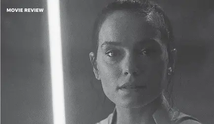  ?? PHOTOS BY LUCASFILM LTD. ?? You can see Rey’s blue lightsaber reflected in her eyes. But what else is she looking at?