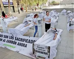  ??  ?? On Thursday, demonstrat­ors take part in a protest called by Greenpeace activists ahead of the 2019 United Nations Climate Change Conference, also known as COP25, in Santiago, Chile. The placards read: “These are the sacrificed, end to the coal now” and “President: coal poisons us” Reuters/Rodrigo Garrido