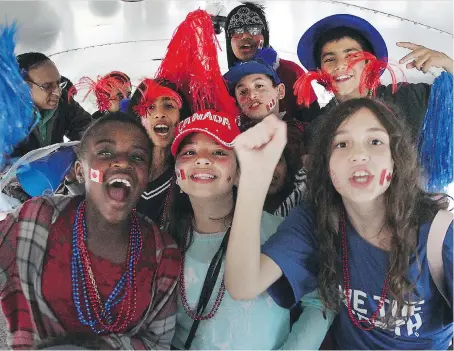  ?? DAN JANISSE ?? Students from Northwood Public School, newcomers to Canada, were in a celebrator­y mood on their way to the WFCU Centre to watch the hometown Spitfires play the Erie Otters in Memorial Cup round-robin play. For most, it was their first time attending a...