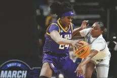  ?? MARY ALTAFFER/AP ?? UCLA GUARD LONDYNN JONES (RIGHT) tries to strip the ball from LSU guard Aneesah Morrow (24) during the third quarter of a game on Saturday in Albany, N.Y.