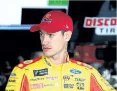  ?? TIM BRADBURY/GETTY IMAGES ?? Joey Logano, driver of the No. 22 Discount Tire Ford, stands in the garage area during practice for the NASCAR XFINITY Series Sparks Energy 300 at Talladega Superspeed­way on Thursday.