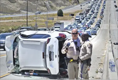  ?? Dan Watson/The SIgnal ?? A vehicle overturned on the northbound 14 Freeway near Placerita Canyon Road in Newhall snarled up traffic for miles on Friday.