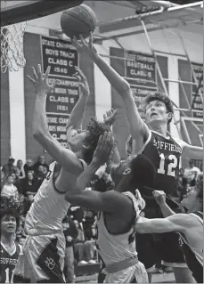  ?? DANA JENSEN/THE DAY ?? Griswold High School’s Jacob Strain, left, and Jeff Souvenance, middle, go after a rebound against Suffield’s Nick Sattan (12) and Nick Van Cott (4) during a Division IV state tournament boys’ basketball game Thursday. Griswold won 6545 to advance to the quarterfin­als. Visit www.theday. com for a photo gallery from the game.