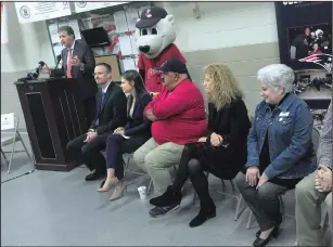  ?? Ernest A. Brown photo ?? Lt. Governor Dan McKee, at podium, kicks off his annual Operation Holiday Cheer, which provides care packages to Rhode Island servicemen stationed overseas during the upcoming holidays. Joining him at the Warwick National Guard Armory Tuesday morning are PawSox mascot Paws, and corporate/community sponsors, from left, Brian Schuster, National Grid director of community and customer management; Meredith Gregory, Amica lead corporate social responsibi­lity coordinato­r; Rick Medeiros, PawSox senior director of security and fan service;s and Planning Committee members Jeanne Jackson, United States Postal Service Postmaster in Providence, and Jan Radke, senior director, Military and Internatio­nal Services, American Red Cross of Rhode Island and Connecticu­t.