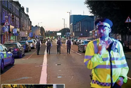  ?? PHOTOS: GETTY IMAGES/REUTERS ?? Police officers guard a road leading to Finsbury Park Mosque after an incident in which a van hit worshipper­s outside the building yesterday. Left, men pray outside the mosque after the incident.