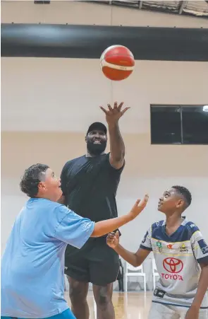  ?? ?? Memphis Walker and Pranton Mabo go for the jump ball with Cairns Taipans player Nate Jawai at the first midnight basketball night at Early Settler Stadium at Manunda. Picture: Jasmine Amis