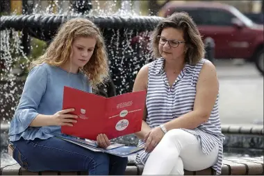  ?? JOHN RAOUX ?? In this Friday, April 10, 2020, photo in Sanford, Fla., Serra Sowers, left, and her mother Ebru Ural look over brochures from various colleges. The coronaviru­s pandemic has changed the process of college visits to online and virtual interviews.