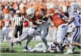  ?? ?? Jonathon Brooks carried the ball 22 times for 112 yards and scored a touchdown as Texas beat Kansas State in overtime to improve to 8-1 on the season.