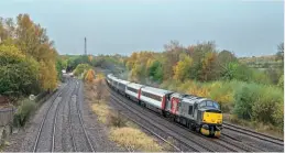  ?? Simon Kerry ?? November 10 saw 11 Mk.3s, operated by the Rail Operations Group, returned to the East Midlands Distributi­on Centre at Castle Donington for stabling. 37510 Orion hauls 5R56 from Derby RTC to Castle Donington.