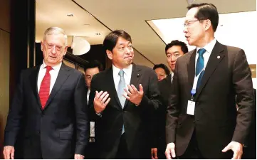  ??  ?? Onodera (centre), Mattis (left) and South Korea’s Defence Minister Song Young-moo leave after a trilateral meeting on the sidelines of the IISS Shangri-la Dialogue in Singapore. — Reuters photo