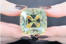  ?? REUTERS ?? The ‘Red Cross Diamond’, a cushion-shaped, 205.07-carat canary yellow diamond, is pictured during the preview.