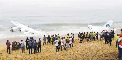  ??  ?? Policemen and rescuers stand near the wreckage of a cargo plane after it crashed in the sea near the airport in Abidjan, Ivory Coast on Saturday. Four Moldovan nationals were killed and three French soldiers hurt in the crash.