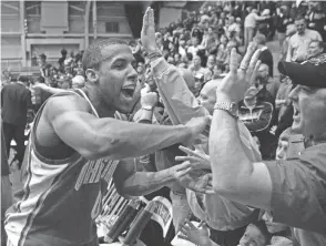  ?? BRIAN KERSEY/AP ?? Swingman J.J. Sullinger celebrates Ohio State’s victory at Northweste­rn with Buckeyes fans on March 1, 2006, a win that clinched a share of the Big Ten title for OSU.