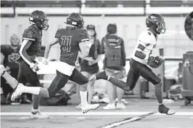  ?? BRYAN TERRY/THE OKLAHOMAN ?? Tulsa Washington's Micah Tease runs to the end zone past Southmoore's Kyus Henry (2) and Raiden Kremeier after a reception in a 51-7 win on Thursday.