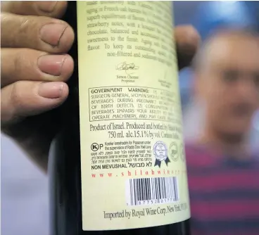  ?? MENAHEM KAHANA / AFP / GETTY IMAGES ?? A Winnipeg university instructor is challengin­g a Canadian Food Inspection Agency decision made last month that allows two wines produced in the West Bank region to be labelled “Products of Israel.” He says Canadian and internatio­nal laws were not...