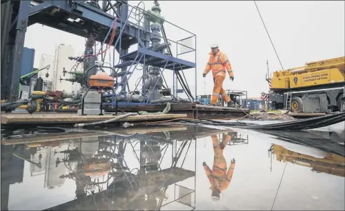  ??  ?? A worker at the Cuadrilla fracking site in Little Plumpton, Lancashire where operations are expected to start next week.