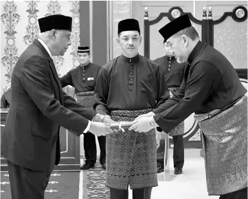  ??  ?? Sultan Muhammad V (right) presenting the instrument of appointmen­t to Dr Prasad at Istana Negara. — Bernama photo