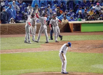  ?? AP Photo/Charles Rex Arbogast ?? Washington Nationals' Michael Taylor (3) celebrates his grand slam as Chicago Cubs relief pitcher Wade Davis looks down during the eighth inning of Game 4 of baseball's National League Division Serie on Wednesday in Chicago.