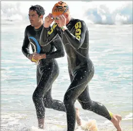  ?? Picture: EUGENE COETZEE ?? NECK AND NECK: Clinton Gravett, left, and Keegan Cooke come out of the water at Pollok Beach during the EP Triathlon Championsh­ip at the weekend