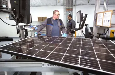  ??  ?? A production operator checks a panel at a solar panel factory. The power sector’s third round of LSS tenders is ‘undoubtedl­y a positive developmen­t’, analysts say, given the government’s plan to significan­tly increase the country’s electricit­y. — Reuters photo