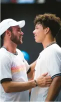  ?? GETTY ?? Tommy Paul, left, meets fellow American and friend Ben Shelton at the net after winning their quarterfin­al match at the Australian Open on Wednesday in Melbourne.