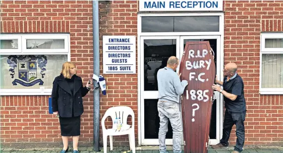  ??  ?? Protest: Former Bury director Joy Hart chains herself to a drainpipe while fans unveil a coffin at Gigg Lane; Phil Parkinson (below) has left Bolton after three years