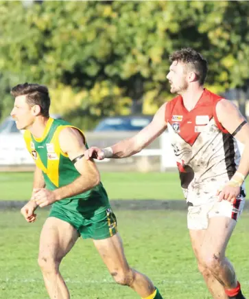  ??  ?? Above: Warragul’s Shaun Beecroft (right), with the big task of playing on prolific Leongatha goalkicker Chris Dunne, was one of the Gulls’ best limiting Dunne to a single goal.