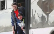  ?? (Alexander Ermochenko/Reuters) ?? CIVILIANS WHO left Mariupol look out of a bus in the village of Bezimenne in the Donetsk Region.