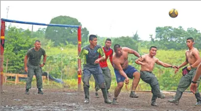  ?? AFERNANDO VERGARA / ASSOCIATED PRESS ?? Rebels of the 48th Front of the Revolution­ary Armed Forces of Colombia play soccer at their camp in the southern jungles of Putumayo, Colombia, early this month.