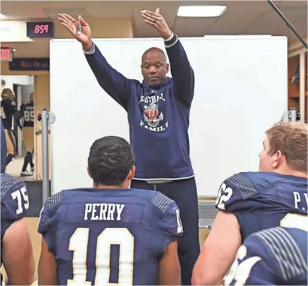  ??  ?? Navy offensive coordinato­r Ivin Jasper gives instructio­ns to his players. PHIL HOFFMANN/NAVAL ACADEMY ATHLETIC ASSOCIATIO­N