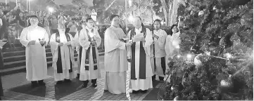  ??  ?? Michael (fifth left) seen blessing the tree with the cathedral’s clergymen and servers.