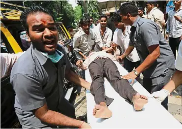  ??  ?? Badly hurt: A stampede victim being carried on a stretcher at a hospital in Mumbai. — Reuters