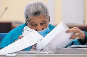  ??  ?? Officials sort ballots during an audit Friday morning at the Floyd County administra­tion building in Rome, Ga. [BEN GRAY/ THE ASSOCIATED PRESS]